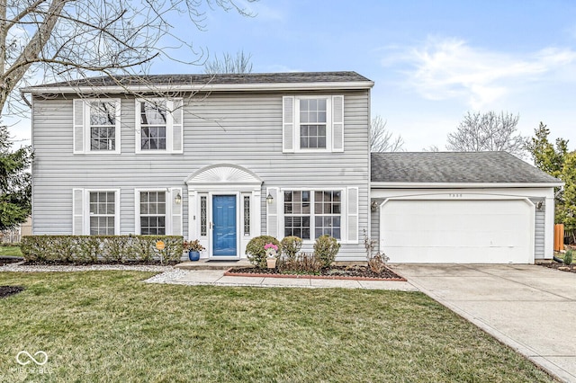 view of front of home with a front yard and a garage