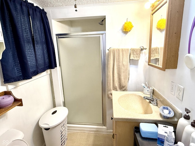 bathroom with vanity, toilet, and a shower with door