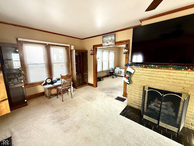 living room with carpet flooring, ceiling fan, crown molding, and a fireplace