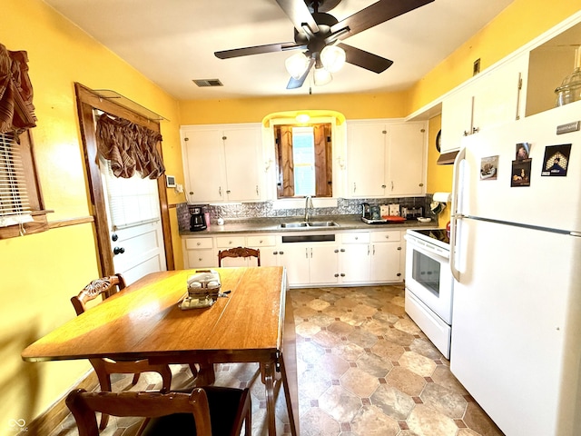 kitchen with white cabinets, white appliances, plenty of natural light, and sink