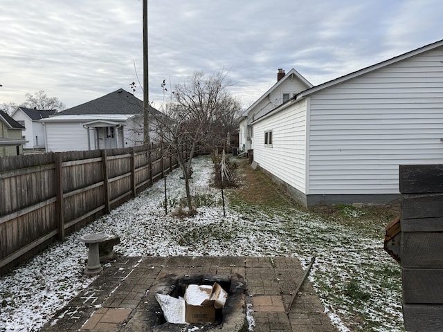 snowy yard featuring a patio