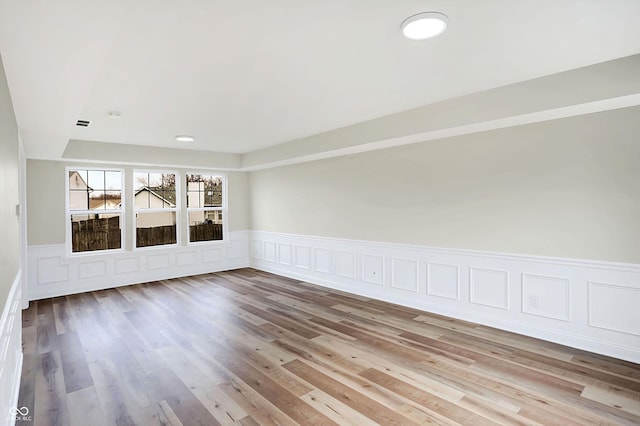 spare room with light hardwood / wood-style floors