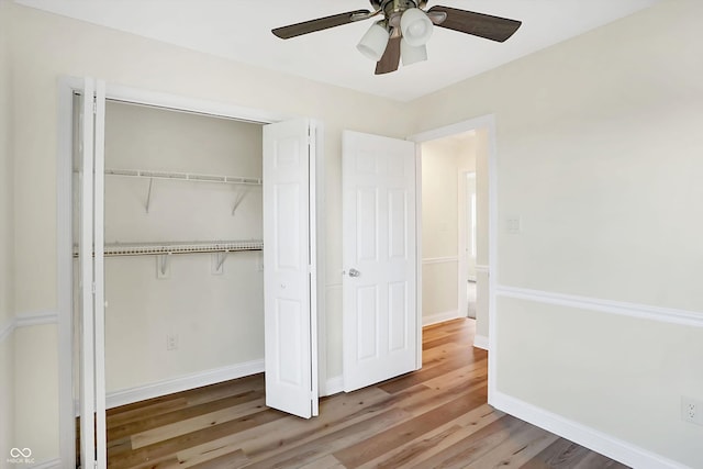 unfurnished bedroom with wood-type flooring, a closet, and ceiling fan