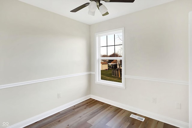 unfurnished room with hardwood / wood-style flooring and ceiling fan