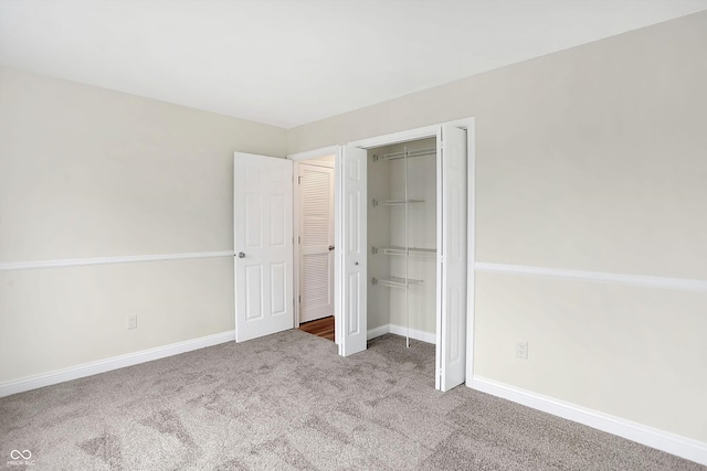 unfurnished bedroom featuring carpet flooring and a closet