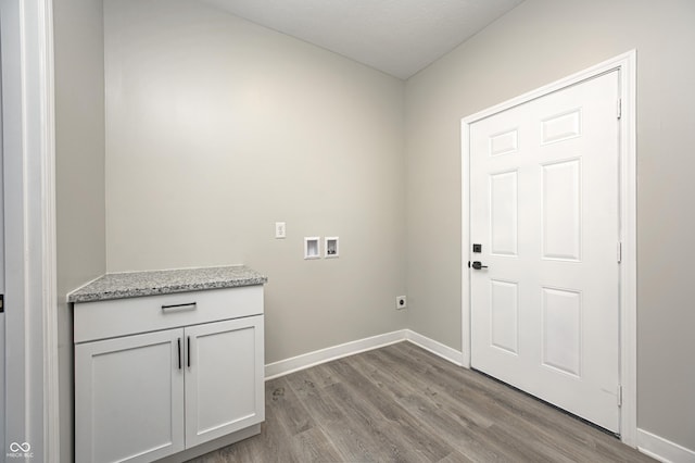 washroom with cabinets, hookup for an electric dryer, light hardwood / wood-style floors, and washer hookup