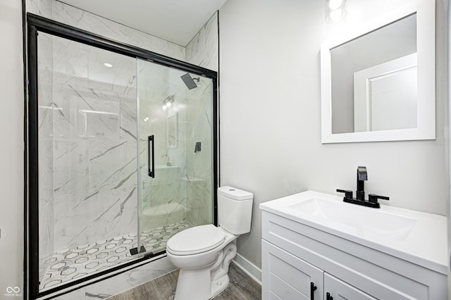 bathroom with wood-type flooring, vanity, toilet, and walk in shower