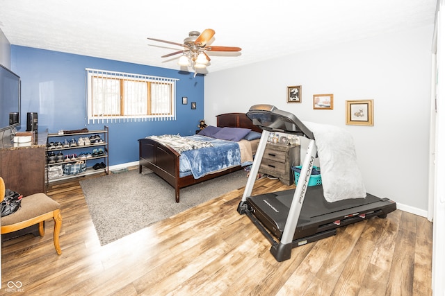 bedroom with ceiling fan and hardwood / wood-style floors