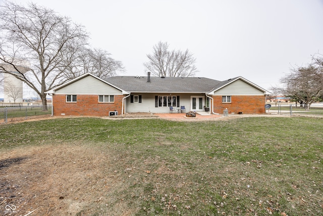 rear view of house featuring a patio area and a lawn