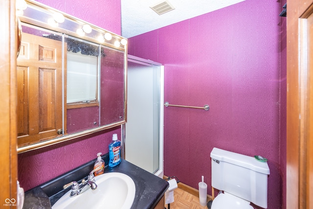 bathroom featuring vanity, toilet, and parquet floors