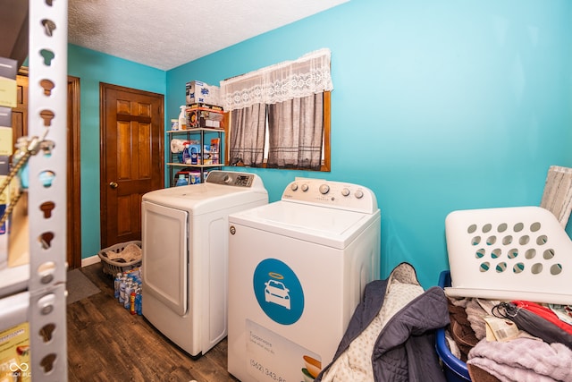 laundry area featuring washing machine and clothes dryer, dark hardwood / wood-style flooring, and a textured ceiling