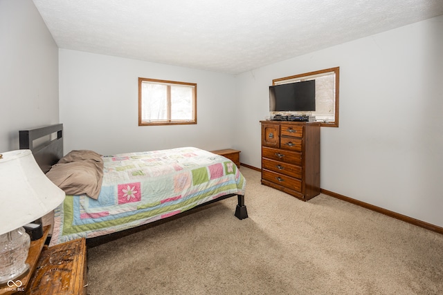 carpeted bedroom with a textured ceiling