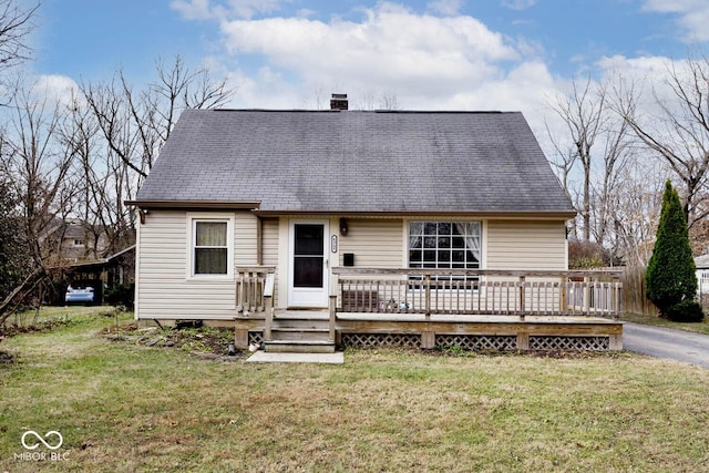 view of front of property with a front yard and a wooden deck