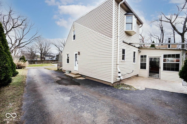 view of property exterior with a patio