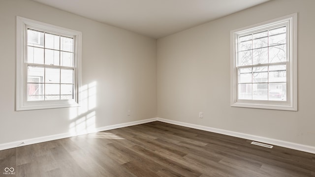 empty room with dark hardwood / wood-style floors