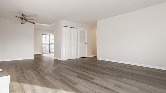 unfurnished room featuring ceiling fan and dark hardwood / wood-style floors