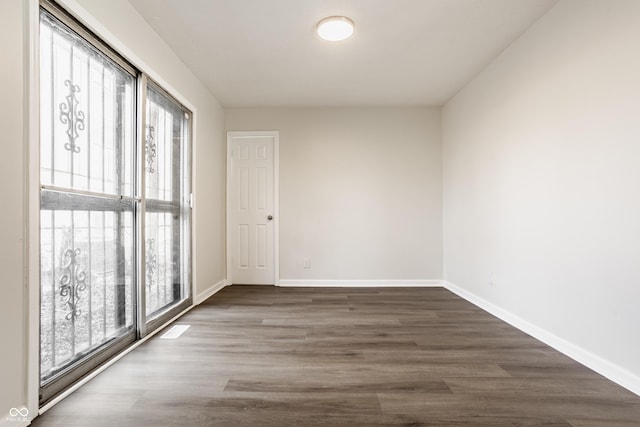 unfurnished room featuring dark hardwood / wood-style floors