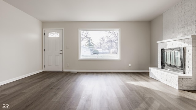 unfurnished living room with a fireplace and wood-type flooring