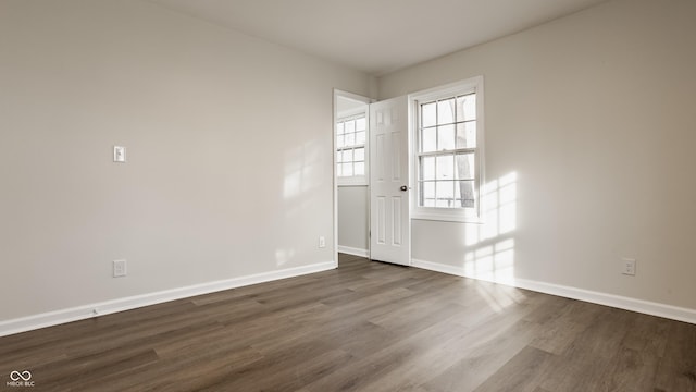 unfurnished room with dark hardwood / wood-style floors