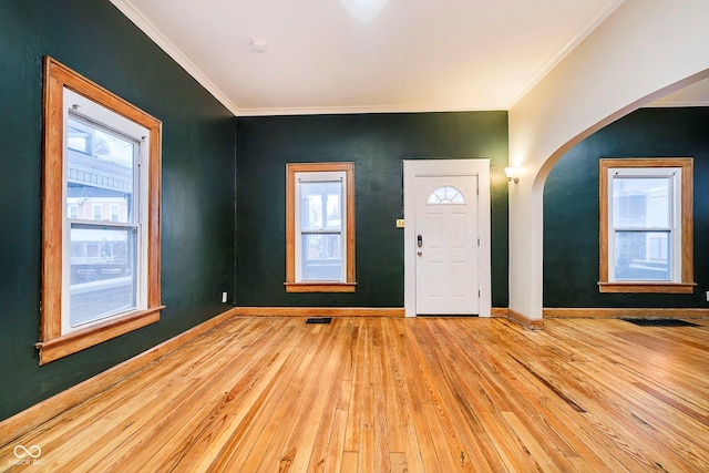 foyer featuring ornamental molding and light hardwood / wood-style flooring