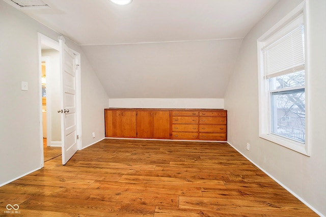 bonus room featuring light hardwood / wood-style floors and lofted ceiling