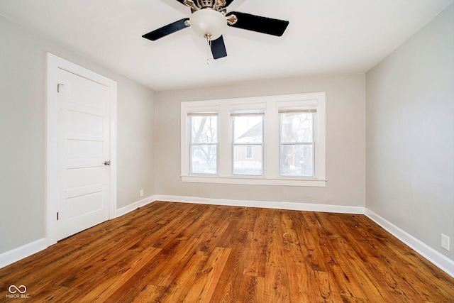 empty room with ceiling fan and wood-type flooring