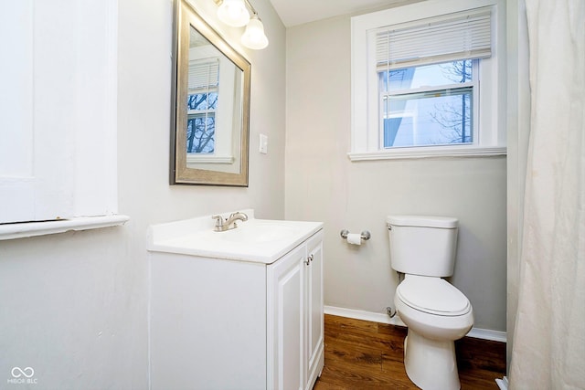 bathroom featuring hardwood / wood-style floors, vanity, and toilet