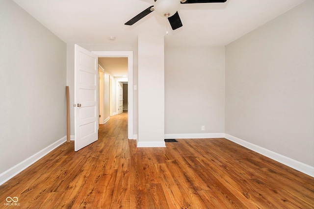 spare room with ceiling fan and hardwood / wood-style floors