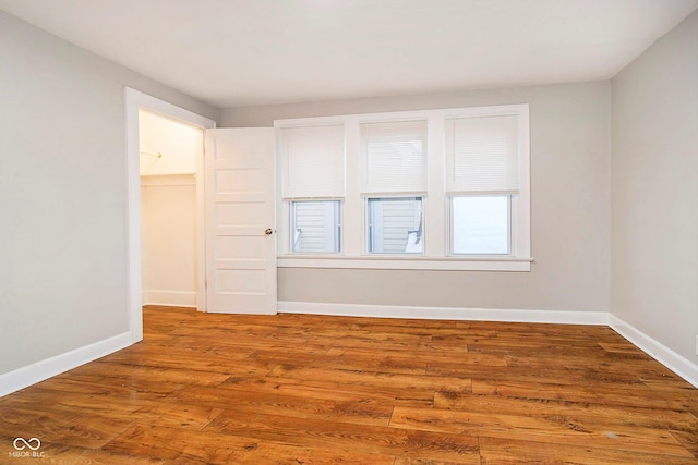 unfurnished room with wood-type flooring and plenty of natural light