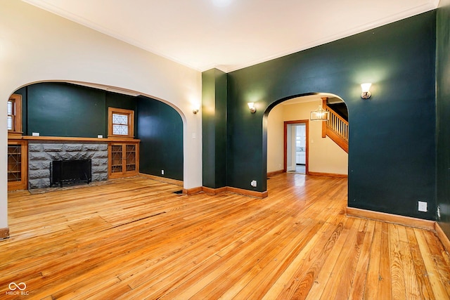 unfurnished living room with a fireplace and light hardwood / wood-style flooring