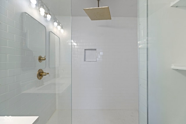 bathroom with a tile shower