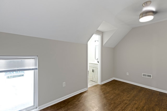 bonus room with dark hardwood / wood-style floors and lofted ceiling