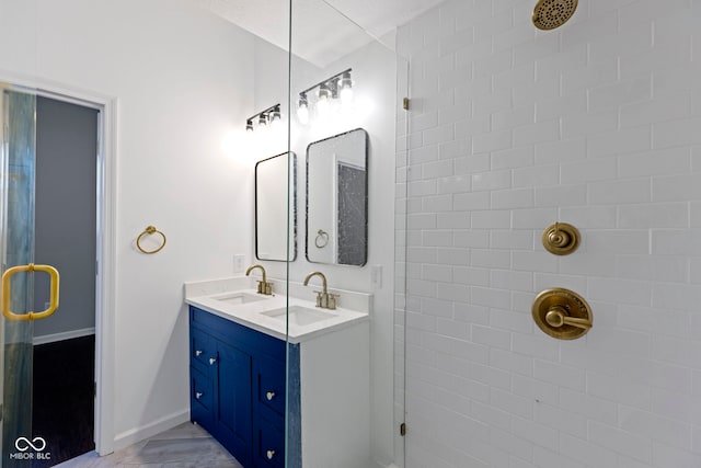 bathroom featuring vanity and tiled shower