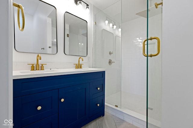 bathroom with tile patterned floors, vanity, and walk in shower