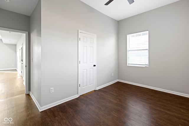 unfurnished room featuring dark hardwood / wood-style floors and ceiling fan