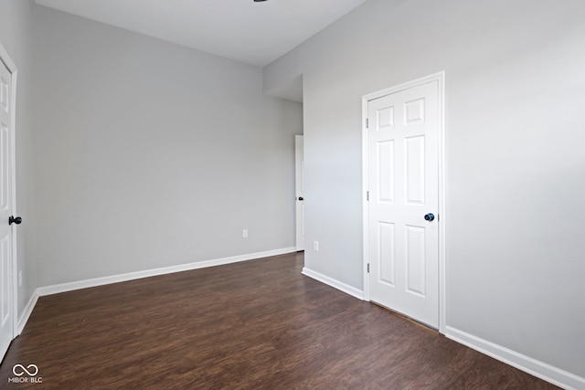 unfurnished bedroom with dark hardwood / wood-style floors