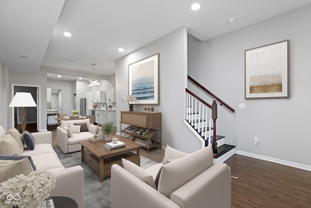 living room with hardwood / wood-style flooring and sink