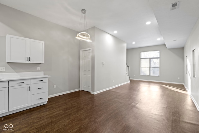 interior space with dark wood-type flooring and a chandelier