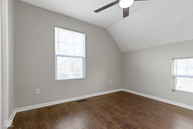 additional living space featuring lofted ceiling, plenty of natural light, ceiling fan, and dark hardwood / wood-style floors