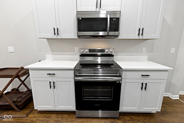 kitchen featuring dark hardwood / wood-style flooring, white cabinets, and stainless steel appliances