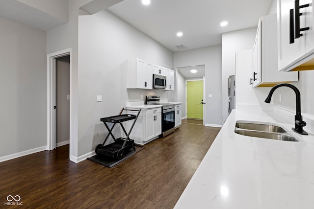 kitchen with white cabinetry, sink, dark hardwood / wood-style floors, and appliances with stainless steel finishes