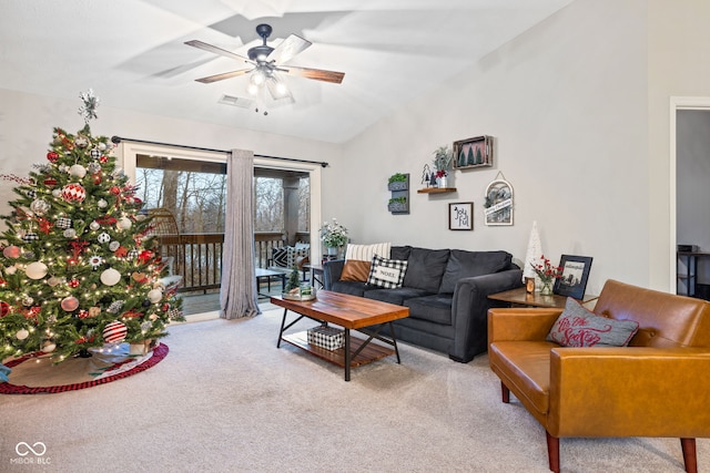 carpeted living room featuring ceiling fan and lofted ceiling