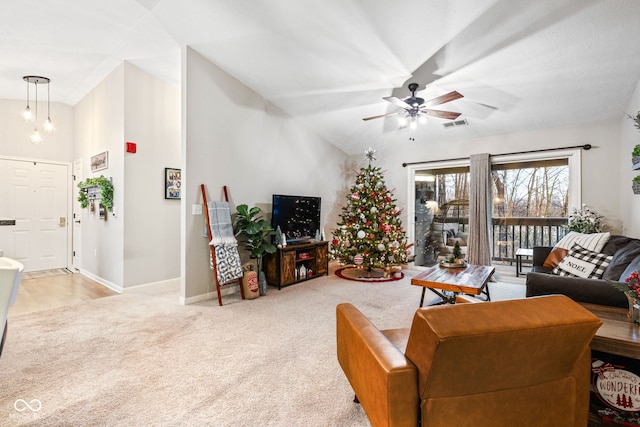 carpeted living room featuring ceiling fan and lofted ceiling