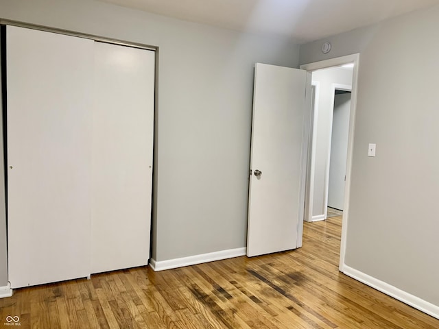 unfurnished bedroom featuring a closet and light hardwood / wood-style floors