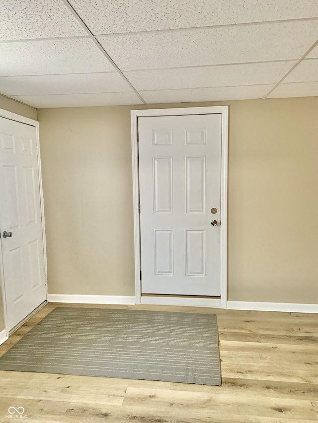 spare room featuring a paneled ceiling and hardwood / wood-style flooring