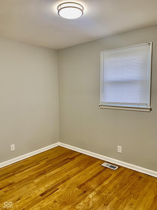 unfurnished room with light hardwood / wood-style floors