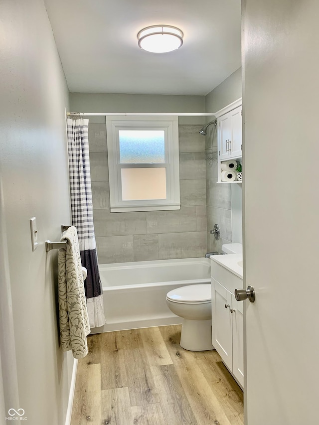 full bathroom featuring vanity, wood-type flooring, shower / tub combo, and toilet