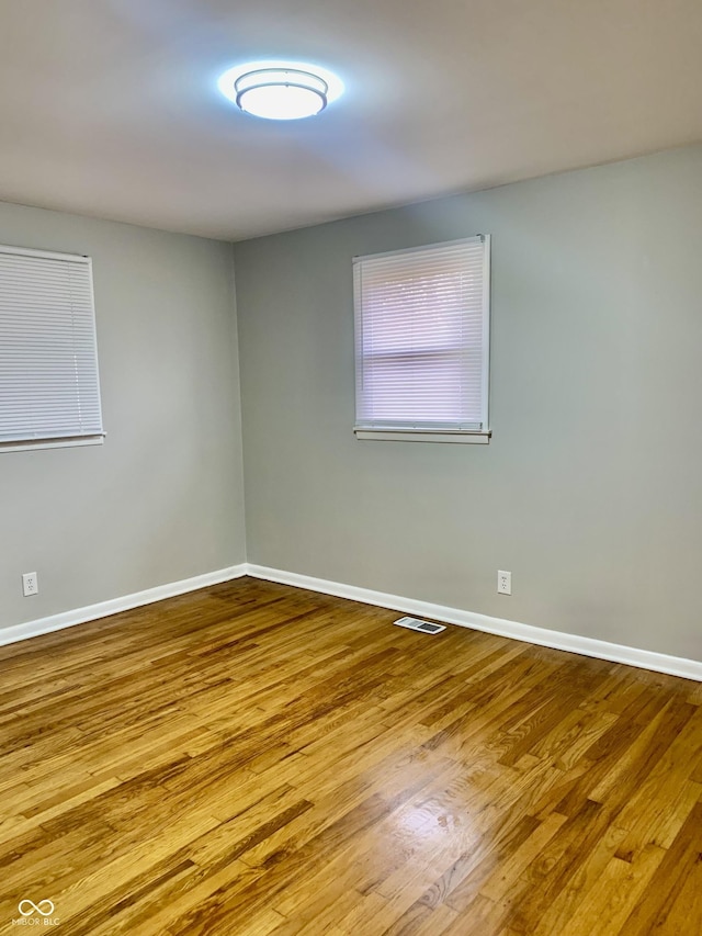 spare room with wood-type flooring