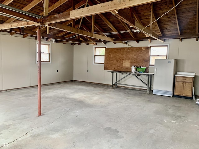 basement featuring white fridge