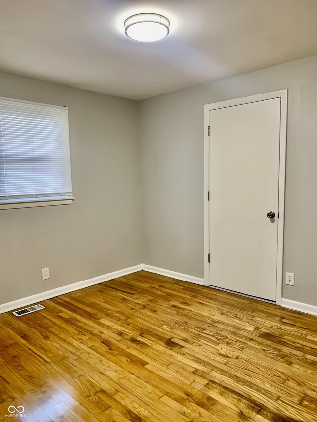 spare room with light hardwood / wood-style flooring